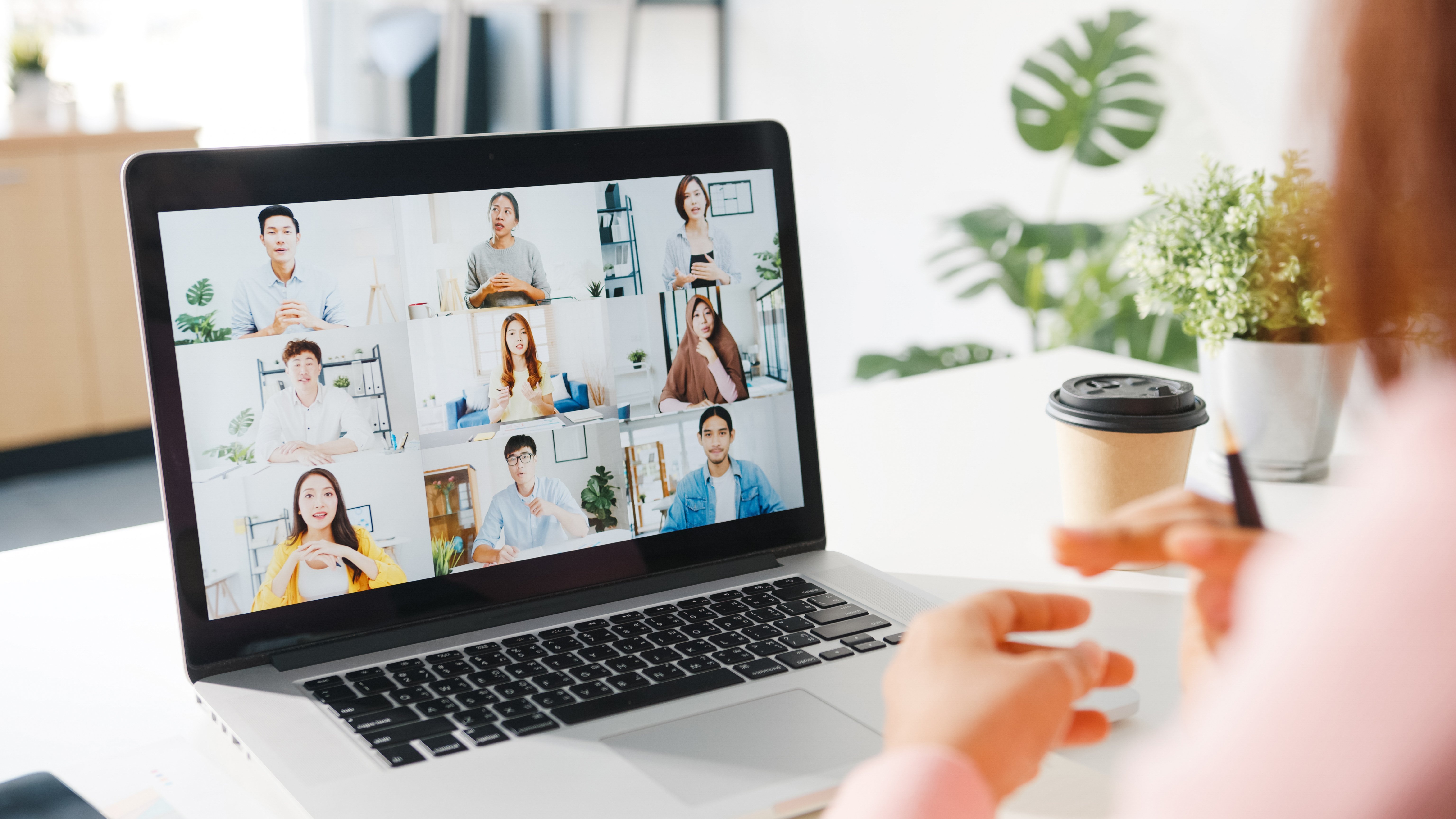 young-asia-businesswoman-using-laptop-talk-colleague-about-plan-video-call-meeting-while-work-from-home-living-room-1