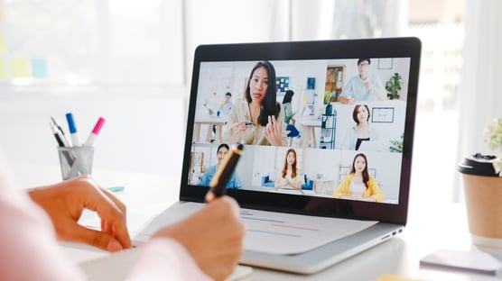 young-asia-businesswoman-using-laptop-talk-colleague-about-plan-video-call-meeting-while-work-from-home-living-room